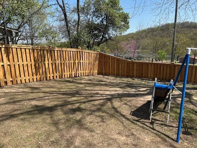 Newly installed cedar picket fence in a residential yard