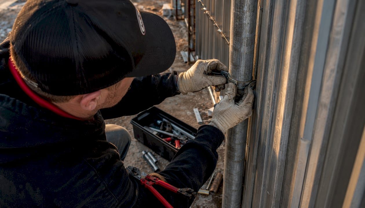 Installer’s hands fixing PostMaster steel clip