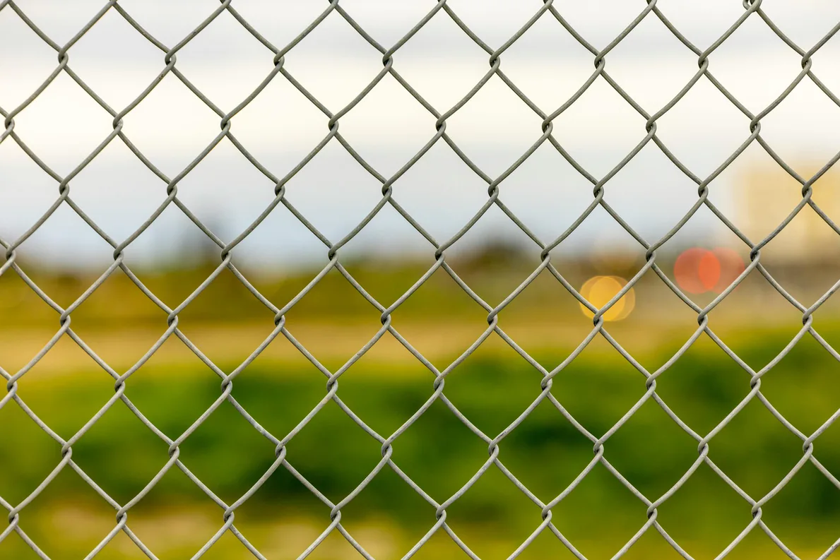 Galvanized chain link fence along a boundary