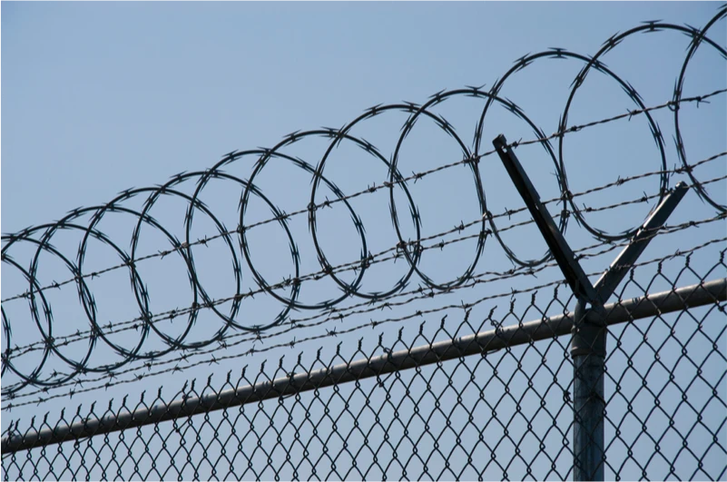 High-security perimeter fence with razor wire topping