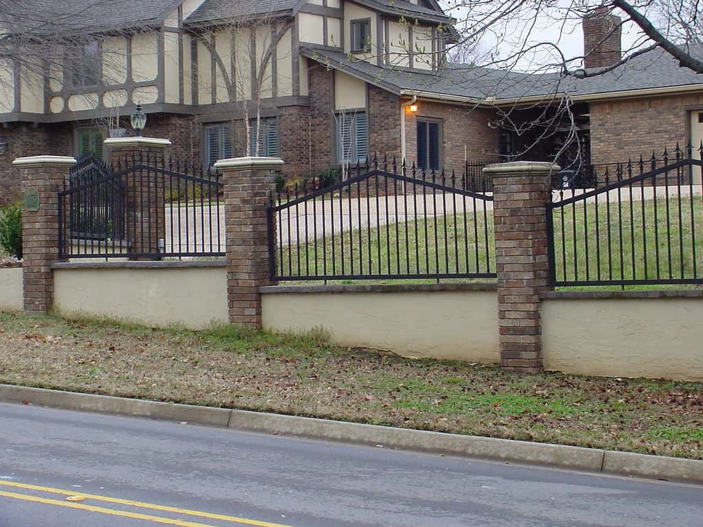 Ornamental iron fence on a masonry wall along the frontage of a professional property