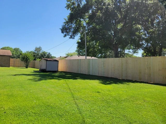 Wood privacy fence stepped down a sloped residential boundary