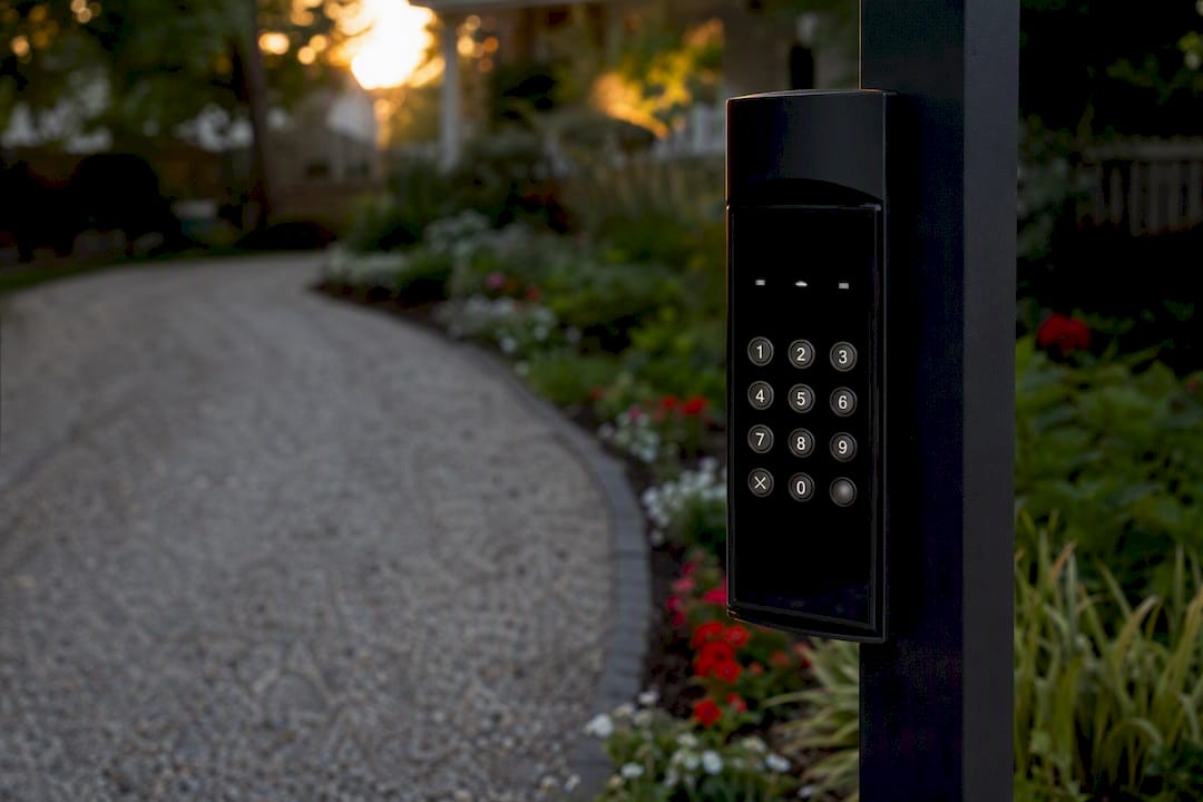 Keypad glare on curved driveway at sunset