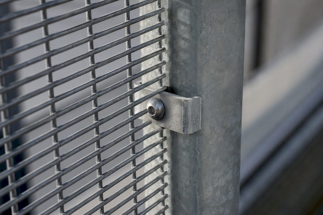 Fence mesh secured with exposed fastener