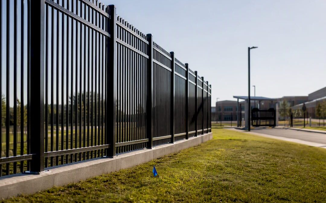School campus perimeter fence along graded ground